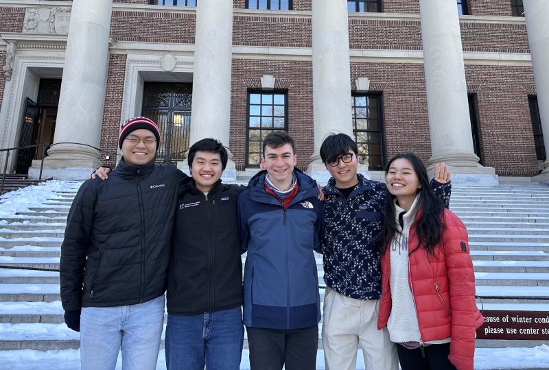 Picture of Raymond and his blocking mates standing in front of the steps of Widener Gate.