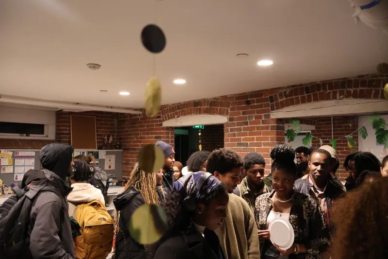 This is a picture of a crowd of Harvard students gathered in a room
