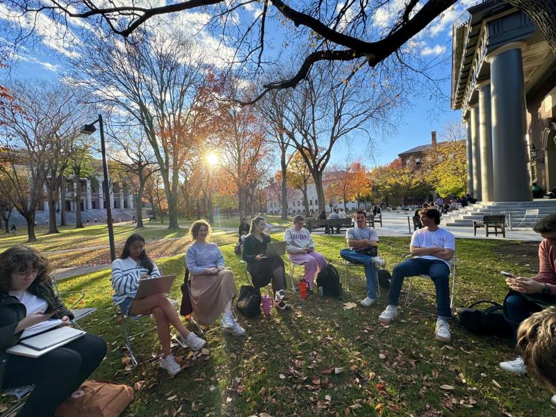 A seminar discussion takes place in Harvard Yard.