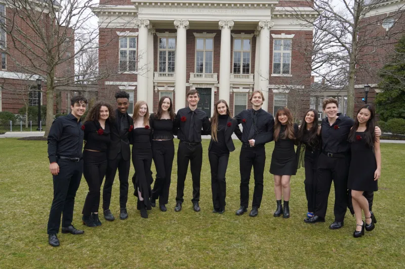 Me with my acapella group wearing all black and a red rose as a fashion point!
