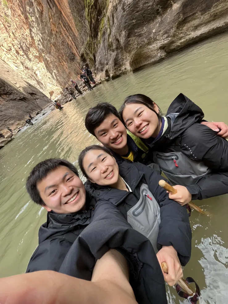 Picture of Raymond and his friends wading through water in the Narrows at Zion National Park.
