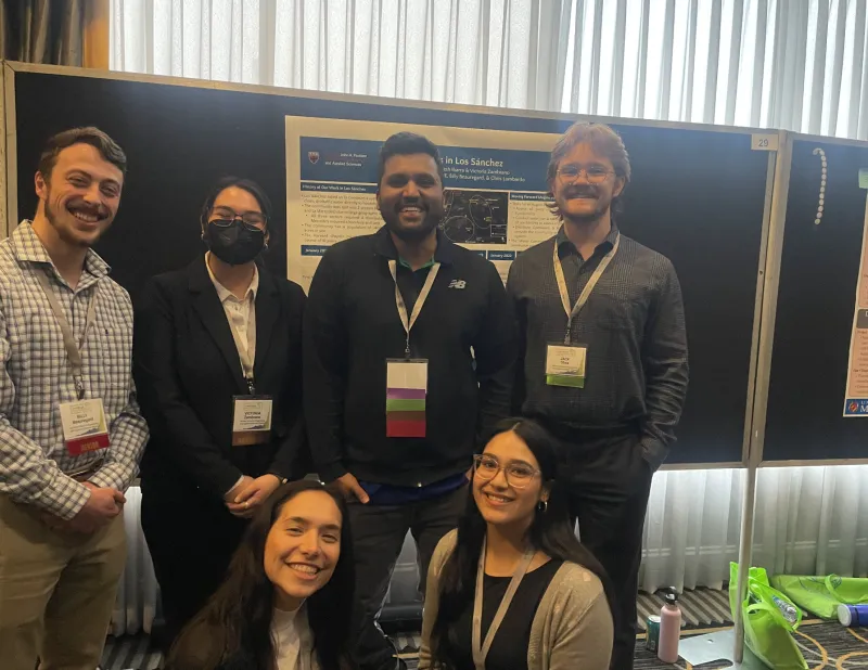Some of the Los Sánchez project team members picture in front of the poster during the poster showcase.