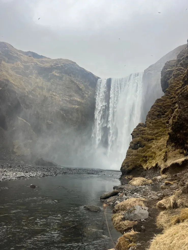 Image of a waterfall flowing into a lake