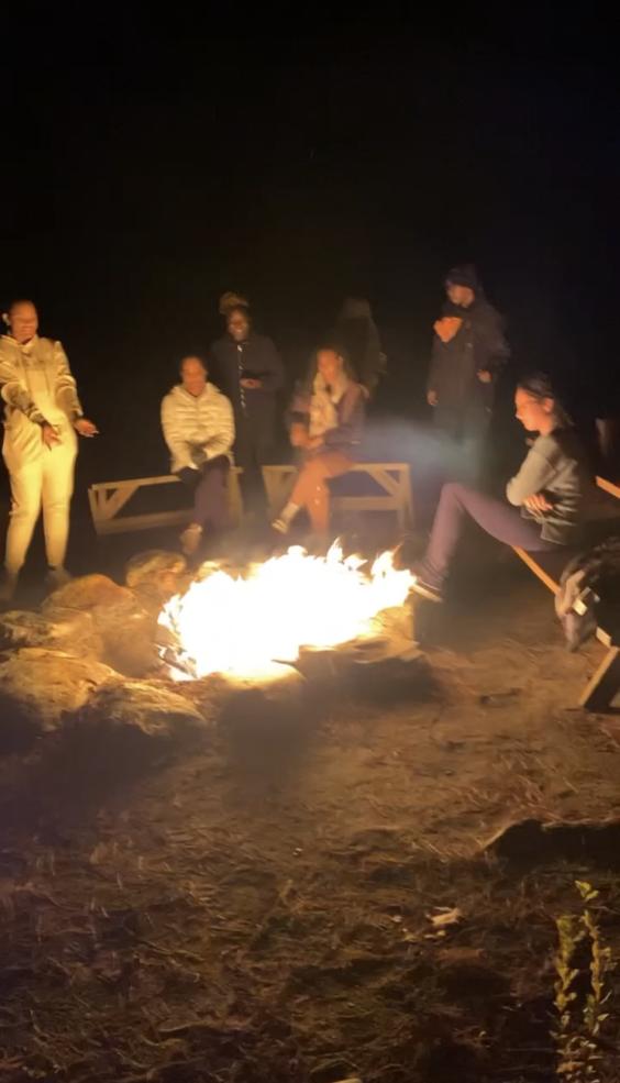 Students Sitting Around Campfire