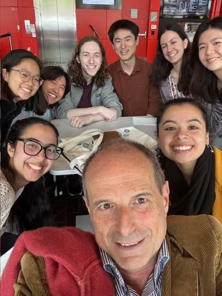 Sitting at a café with Maestro Federico Cortese and my Sib Fam, smiling and enjoying time together outside of rehearsal.