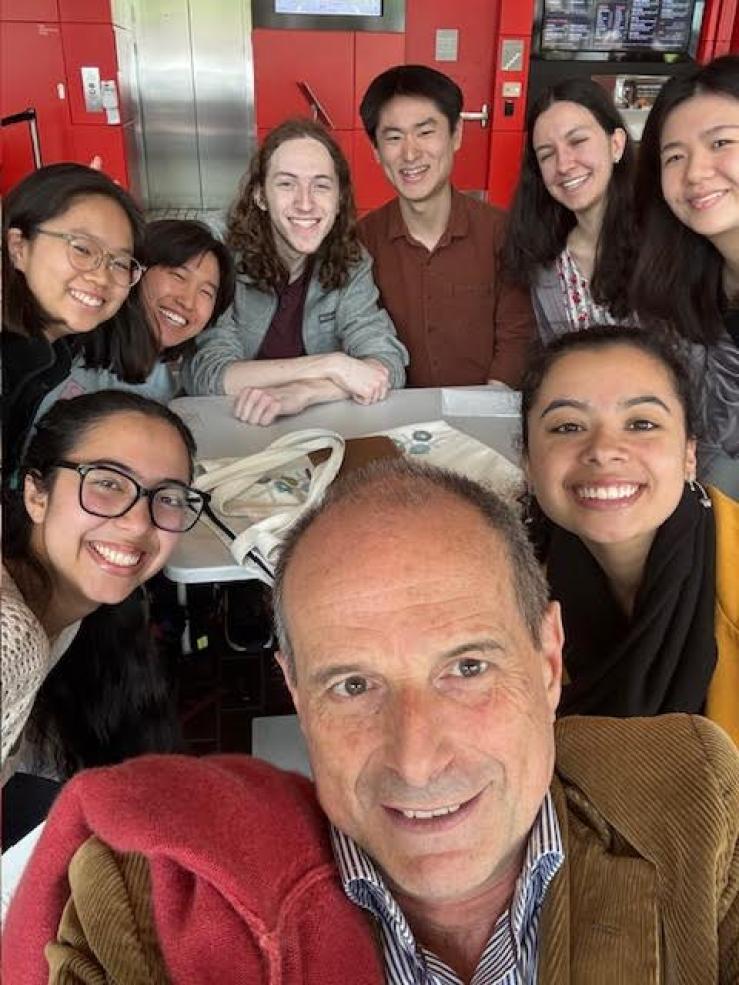 Sitting at a café with Maestro Federico Cortese and my Sib Fam, smiling and enjoying time together outside of rehearsal.