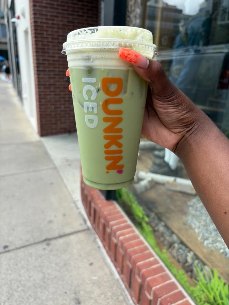 Hand holding Iced Matcha cup from Dunkin