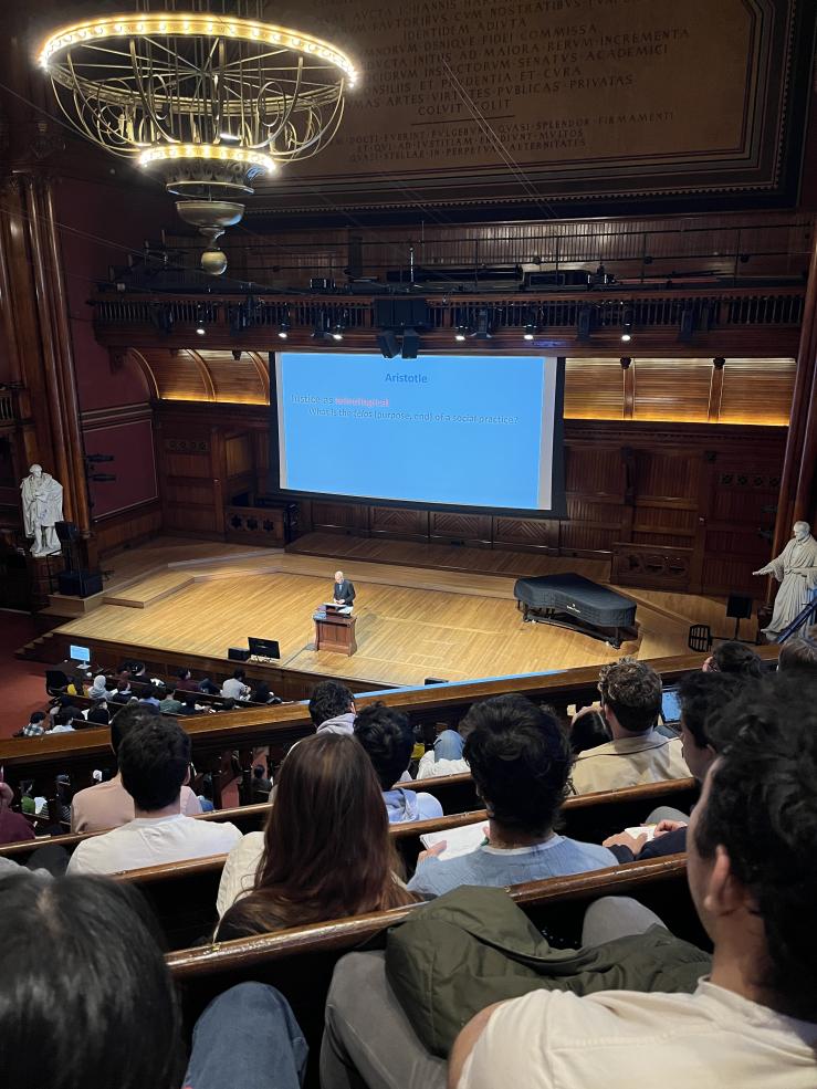 Sanders Theater full of students attending a session of Justice, taught by Michael Sandel.