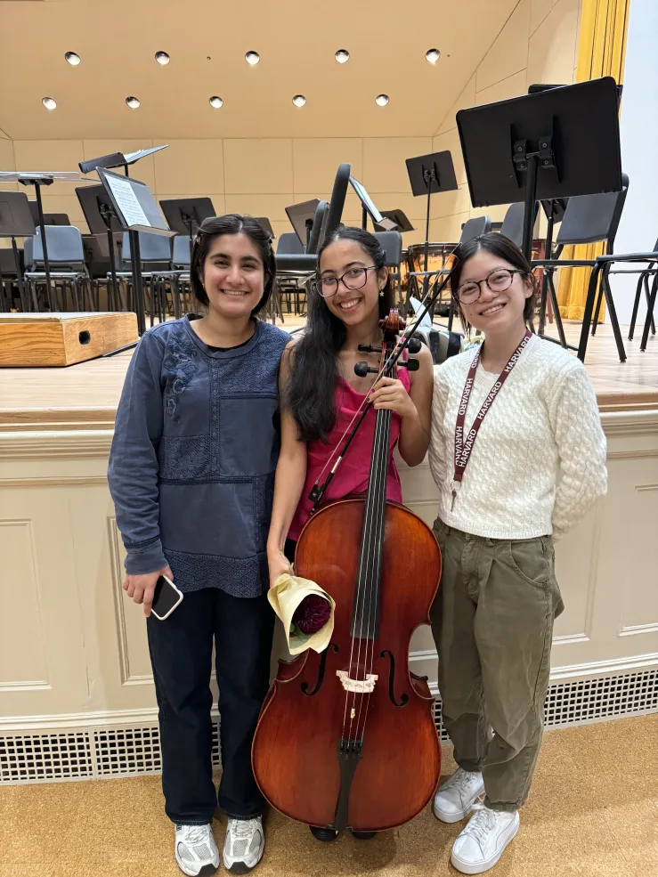 With my roommates at the end of one of my concert holding my cello.