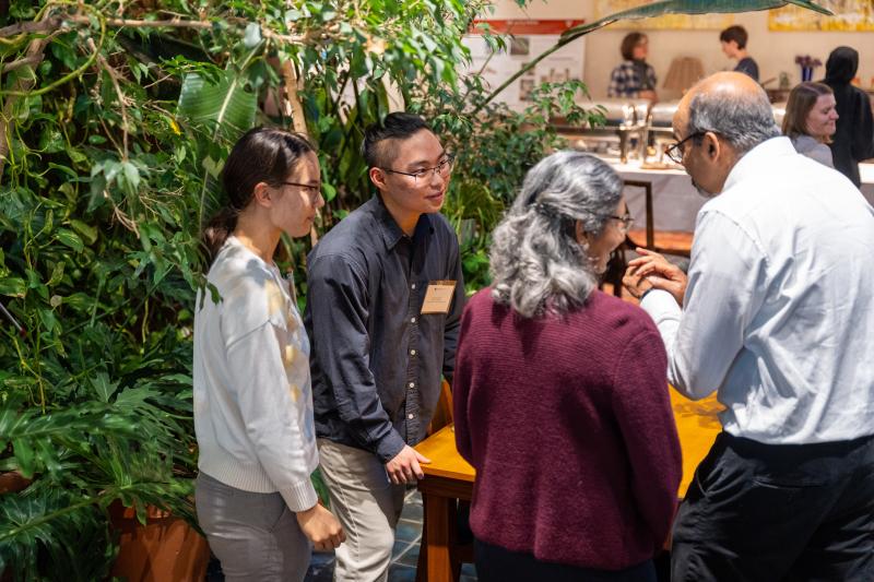 Deans Maha and Amala Mahadevan describe Measure Mather to two Harvard College students. 