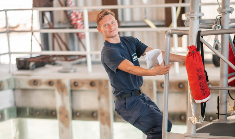 Dmitry climbing a ladder, preparing the boat for mission readiness. 