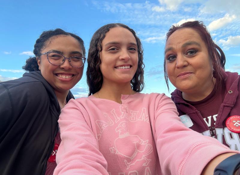 Secquoia, older sister, and mom taking a selfie on terrace outside