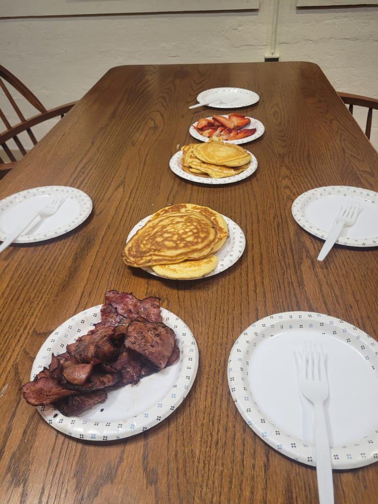 A spread of pancakes, strawberries, and beef bacon Rahma and her friends made together