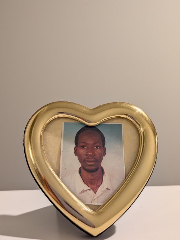 Picture of Rahma's dad in a golden heart shaped frame