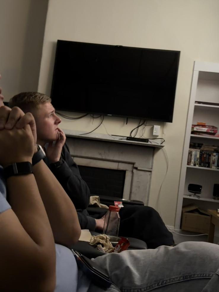 A man looking off at a screen with suspense.