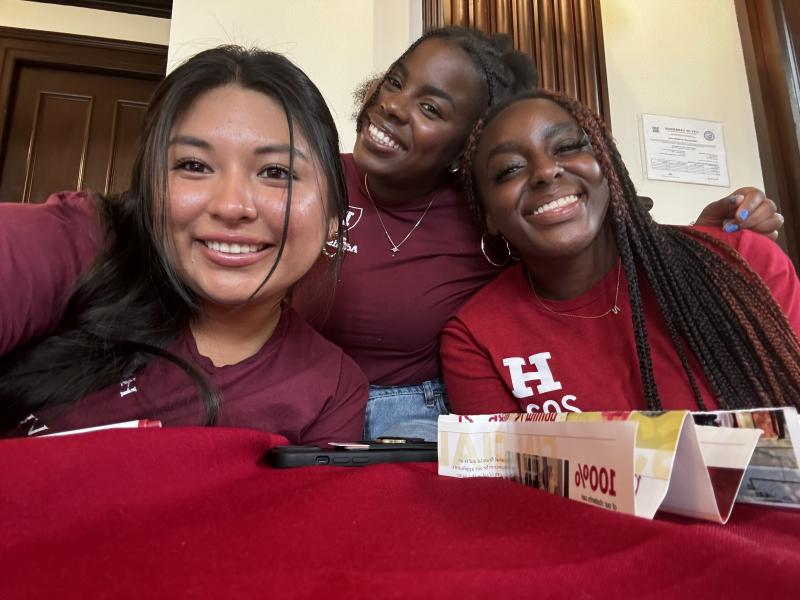 Three students smiling for a picture.