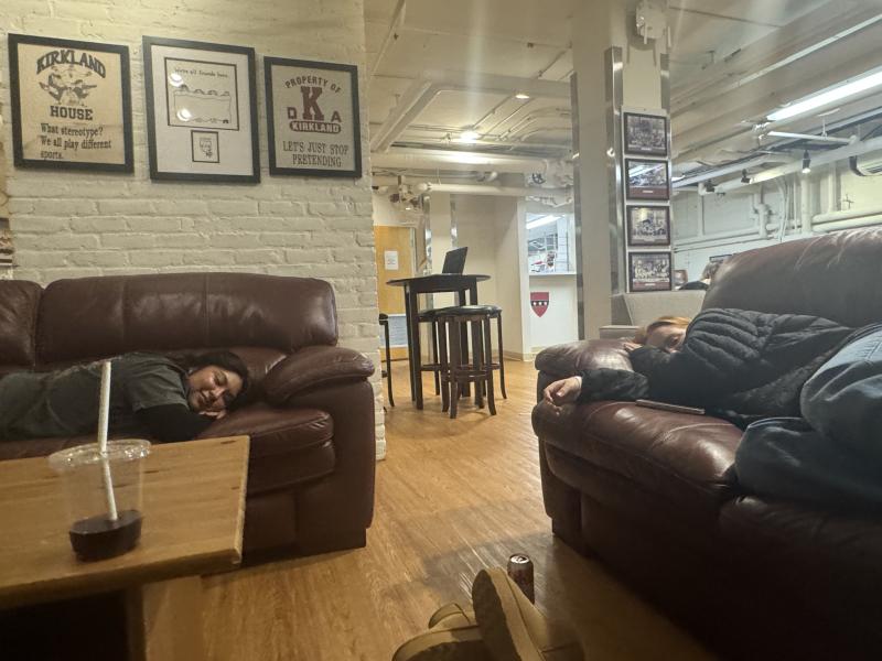 Two students sleeping on couches. 