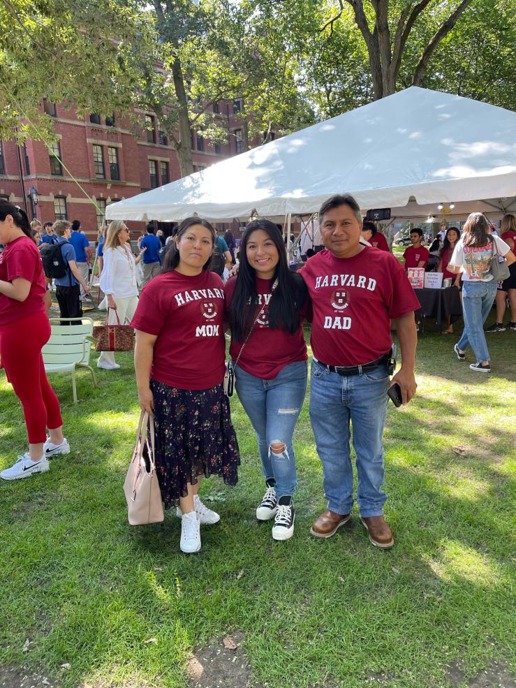 Three people smiling at the camera. 