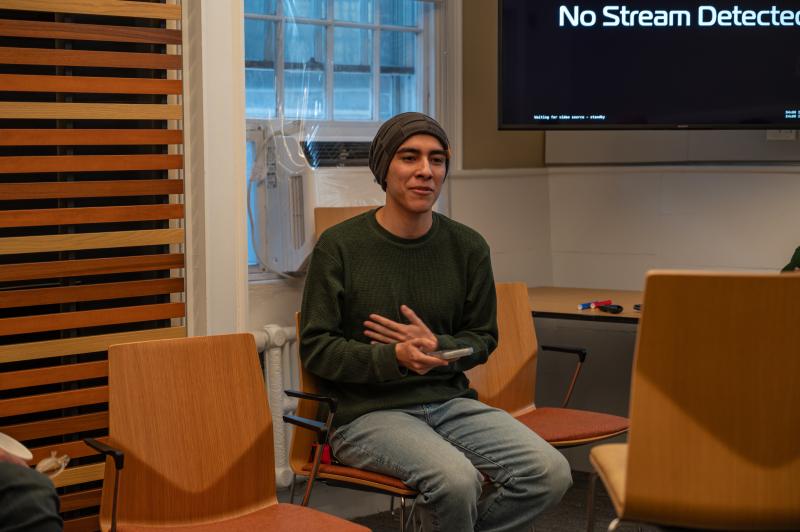 Emiliano Gutierrez Berlanga '28 seated and presenting to the group during the Intro to Creative Entrepreneurship.