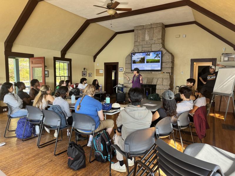 A researcher giving a presentation to students about Waquoit Bay.