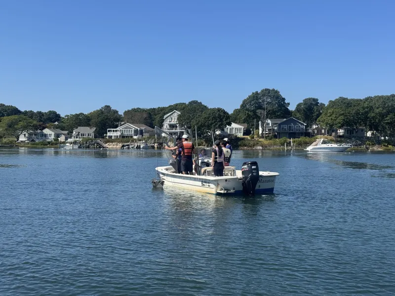 Researcher from Waquoit Bay National Estuarine Research Reserve taking students out on a research boat.