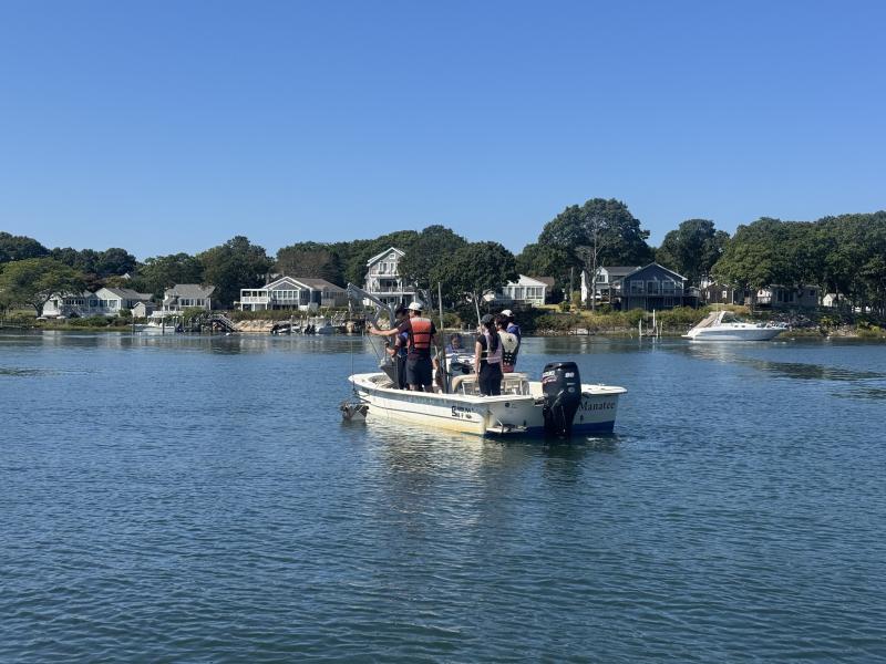 A researcher from Waquoit Bay National Estuarine Reserve taking students out on a research boat.