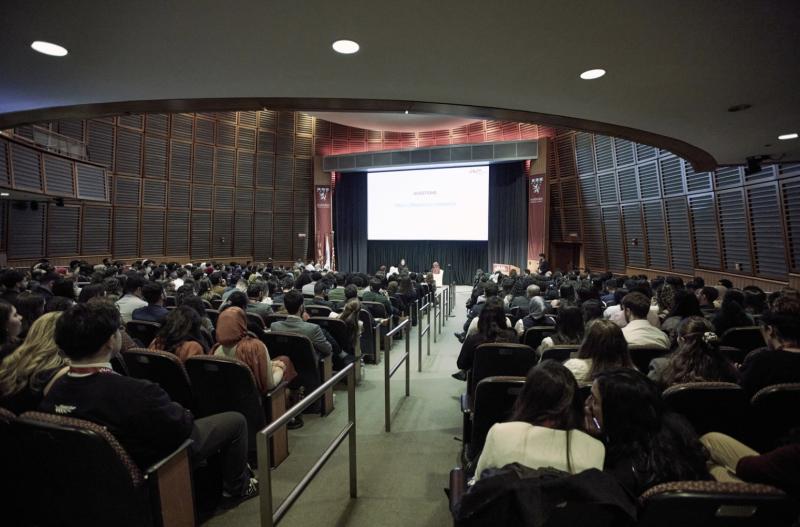 Large auditorium at the Arab Conference at Harvard 2025 with speakers and an audience.