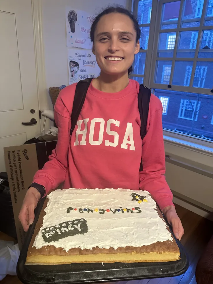Secquoia holding her decorated cake from the Quincy Cake Boss competition