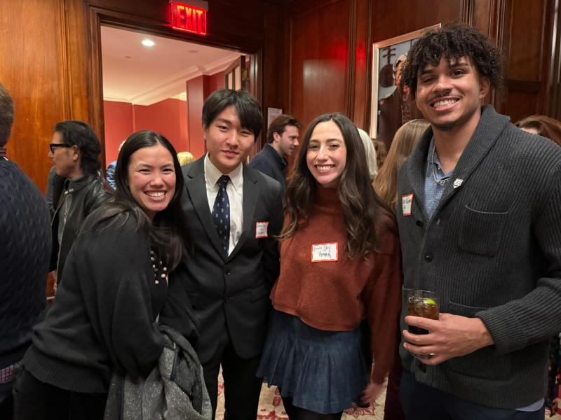 Three students with one alum at the Arts Alumni Mixer.