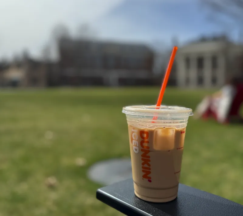 A cup of Dunkin iced coffee outside in the Radcliffe Yard