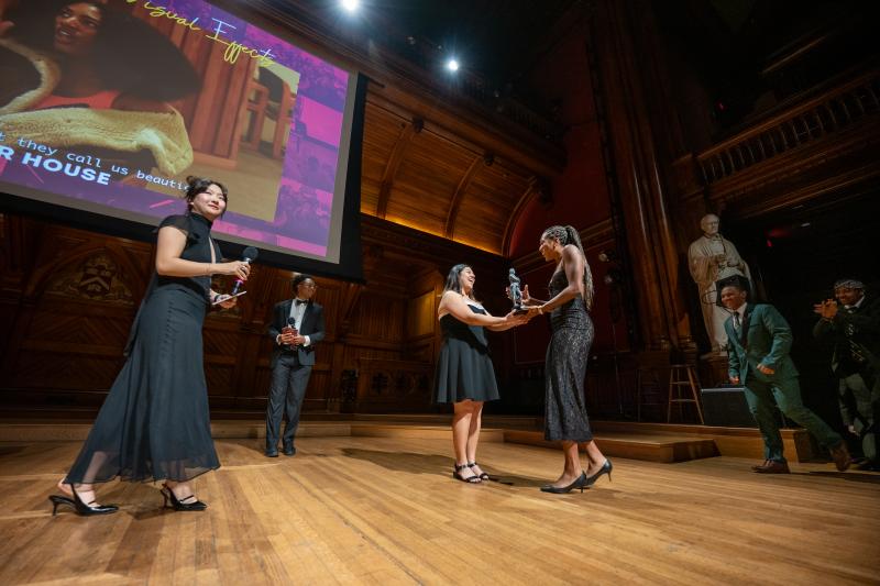A student from Currier House onstage accepted the award for Best Editing & Visual Effects.
