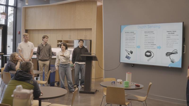 Students learning about depth sensing from a presentation.