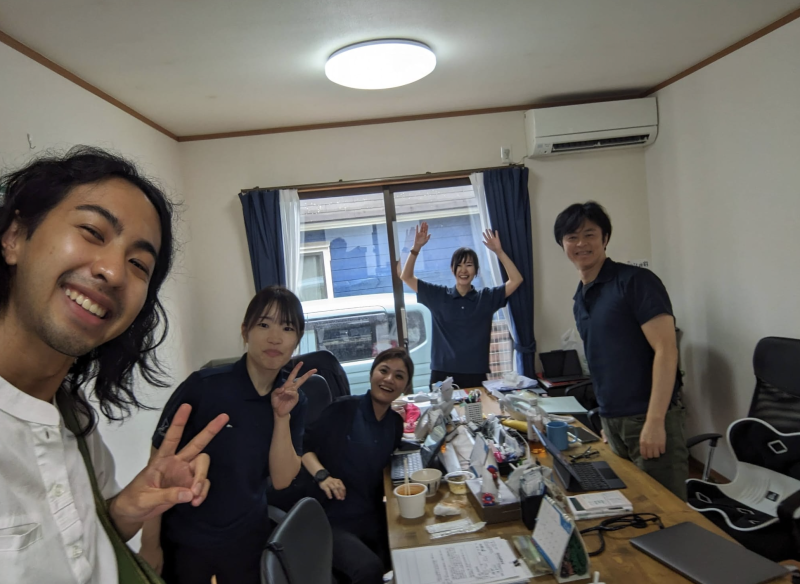 Kai with a group of students in Japan, working on their project.
