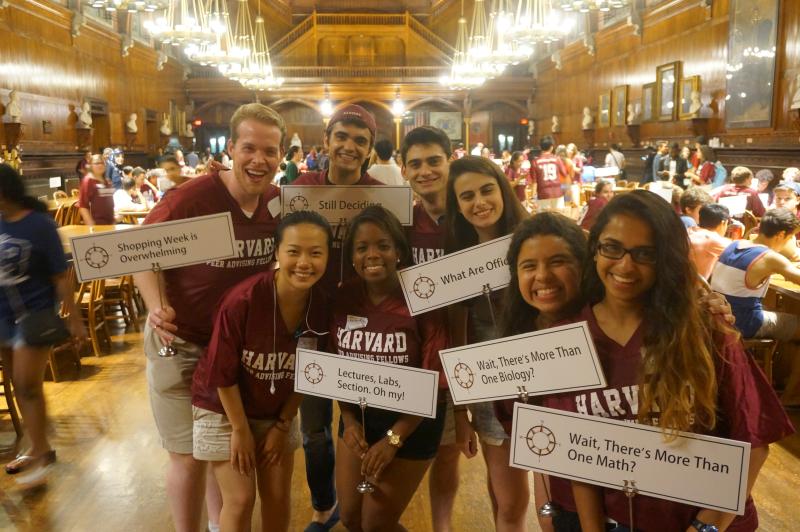 A group of PAFs holding up signs for a study break while wearing matching Crimson shirts inside Annenberg.