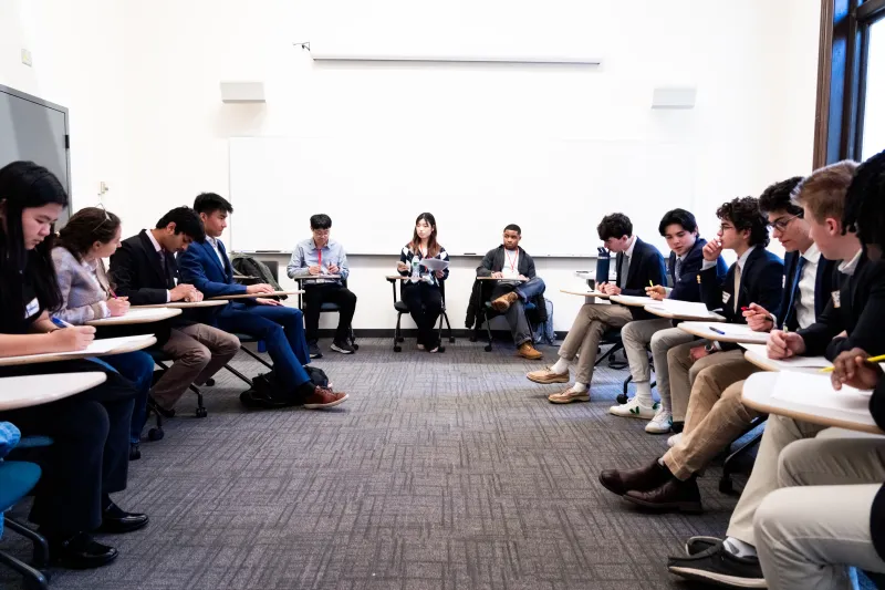 Students sitting seminar-style in a classroom