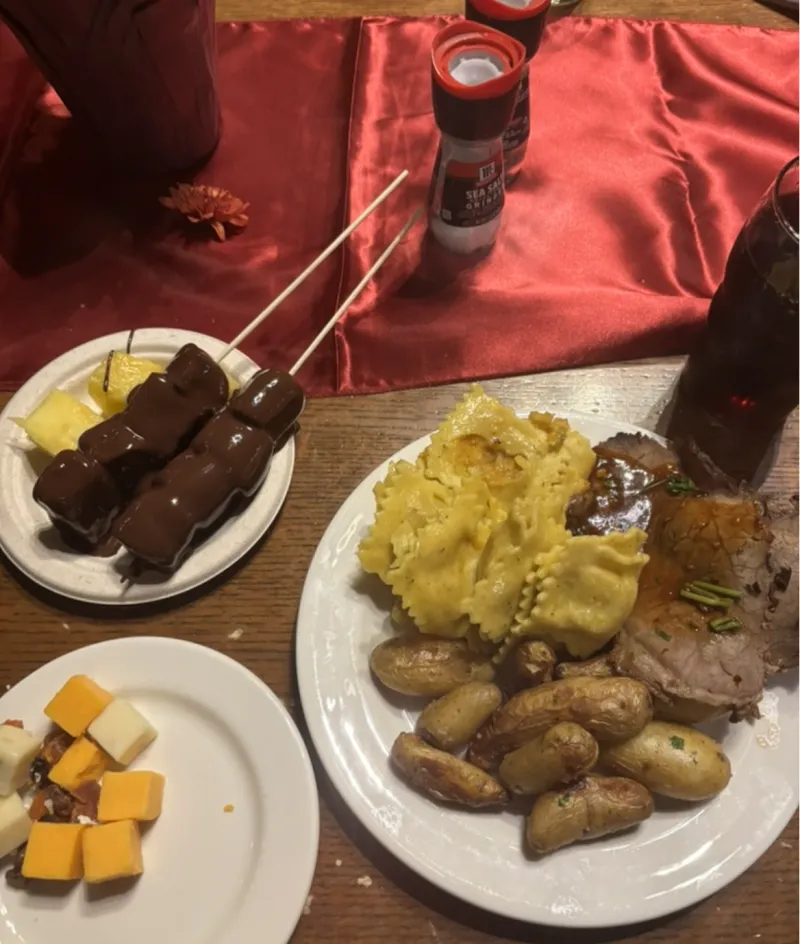 Three plates with cheese, potatoes, pasta, and fondue