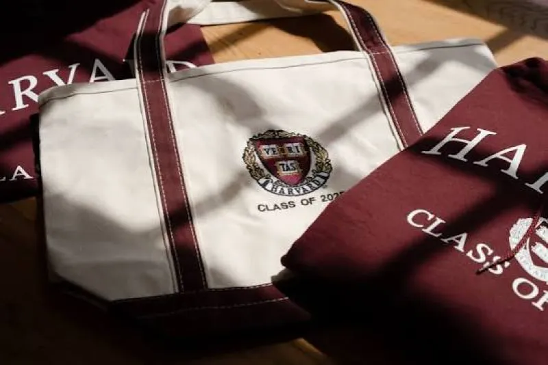 An image of a canvas tote bag featuring the Harvard crest