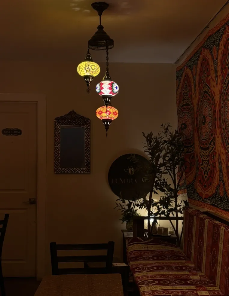 Dark room with lanterns and colorful tapestry