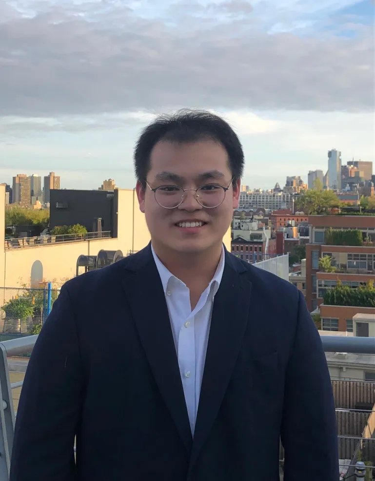 Headshot of Virgil Guo '28 in front of a cityscape.