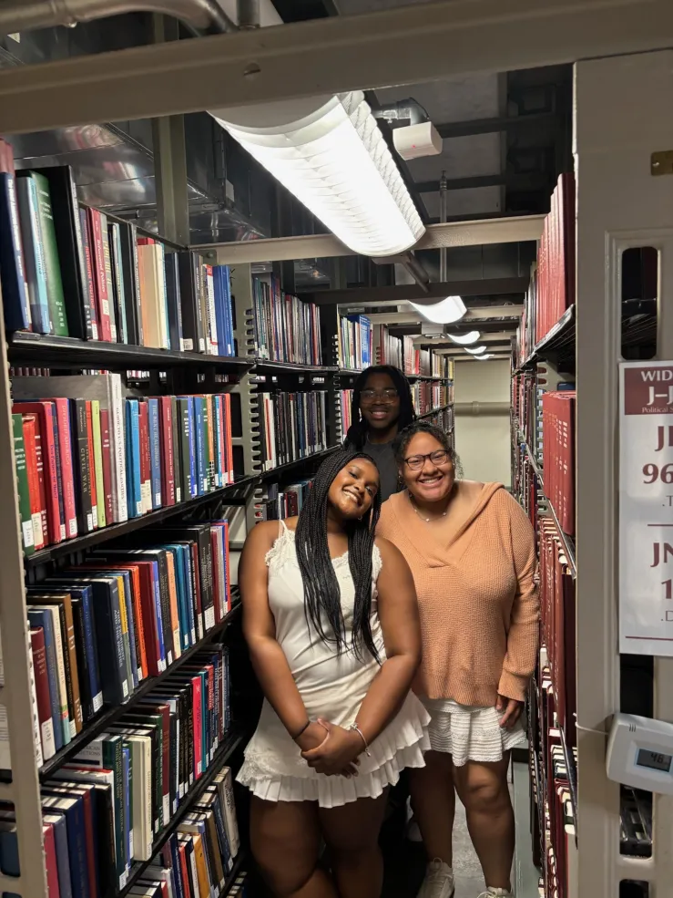 An image of me, SRA Dre'Shon, SRA Angelene in the Widener Stacks