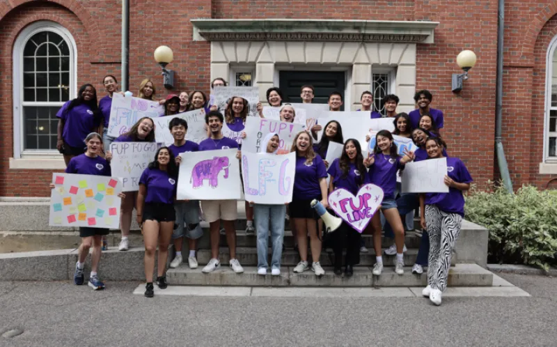 picture of students standing in purple shirts