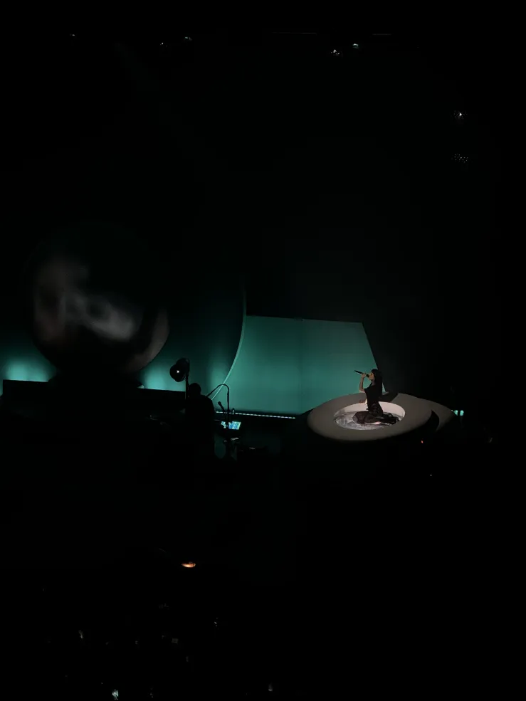 Woman resting on her knees during her performance. 