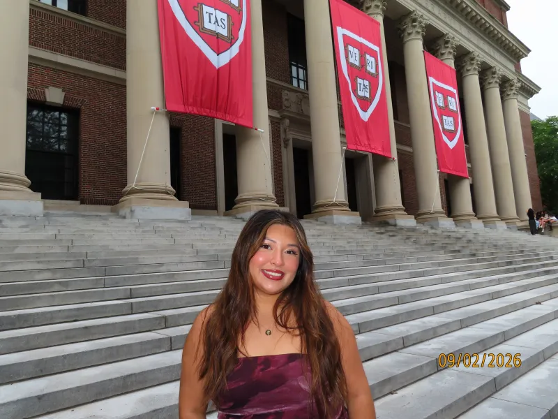 Author posing in front of the three Veritas banners at Widener Library.