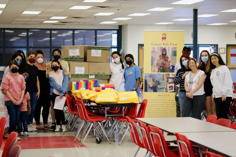 Olivia Zhang '27 with her high school peers at an event she hosted for Cancer Kids First.