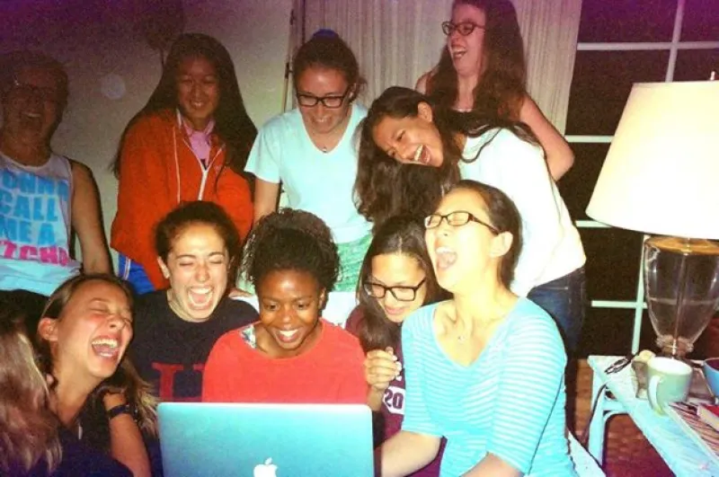 Author laughing with a cappella group over a YouTube video