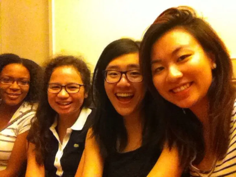 four students smiling