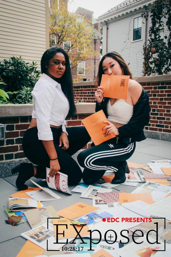 two students kneeling and posing