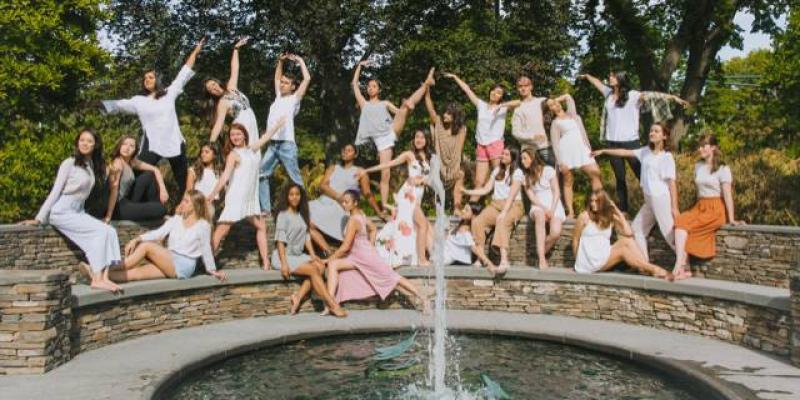 students dancing and posing on a bridge