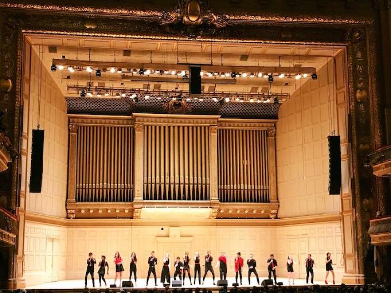 Student group performing on stage