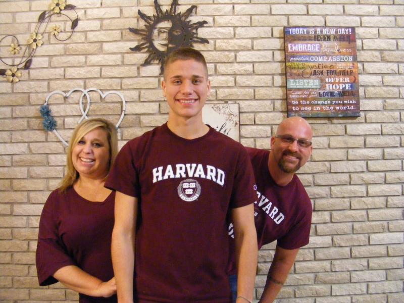 Braeden with his parents, wearing matching Harvard t-shirts. 